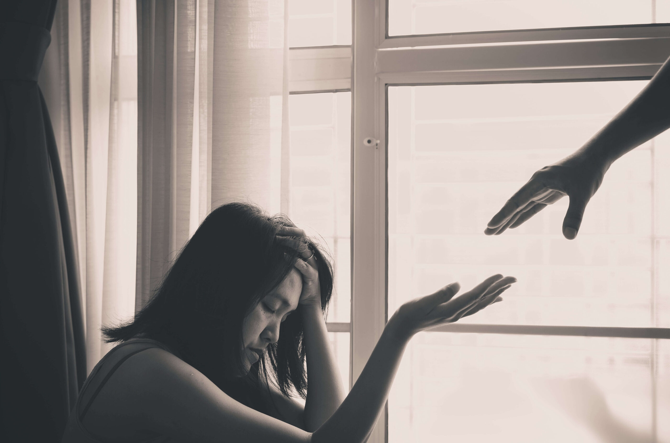 hand helping woman struggling with addiction