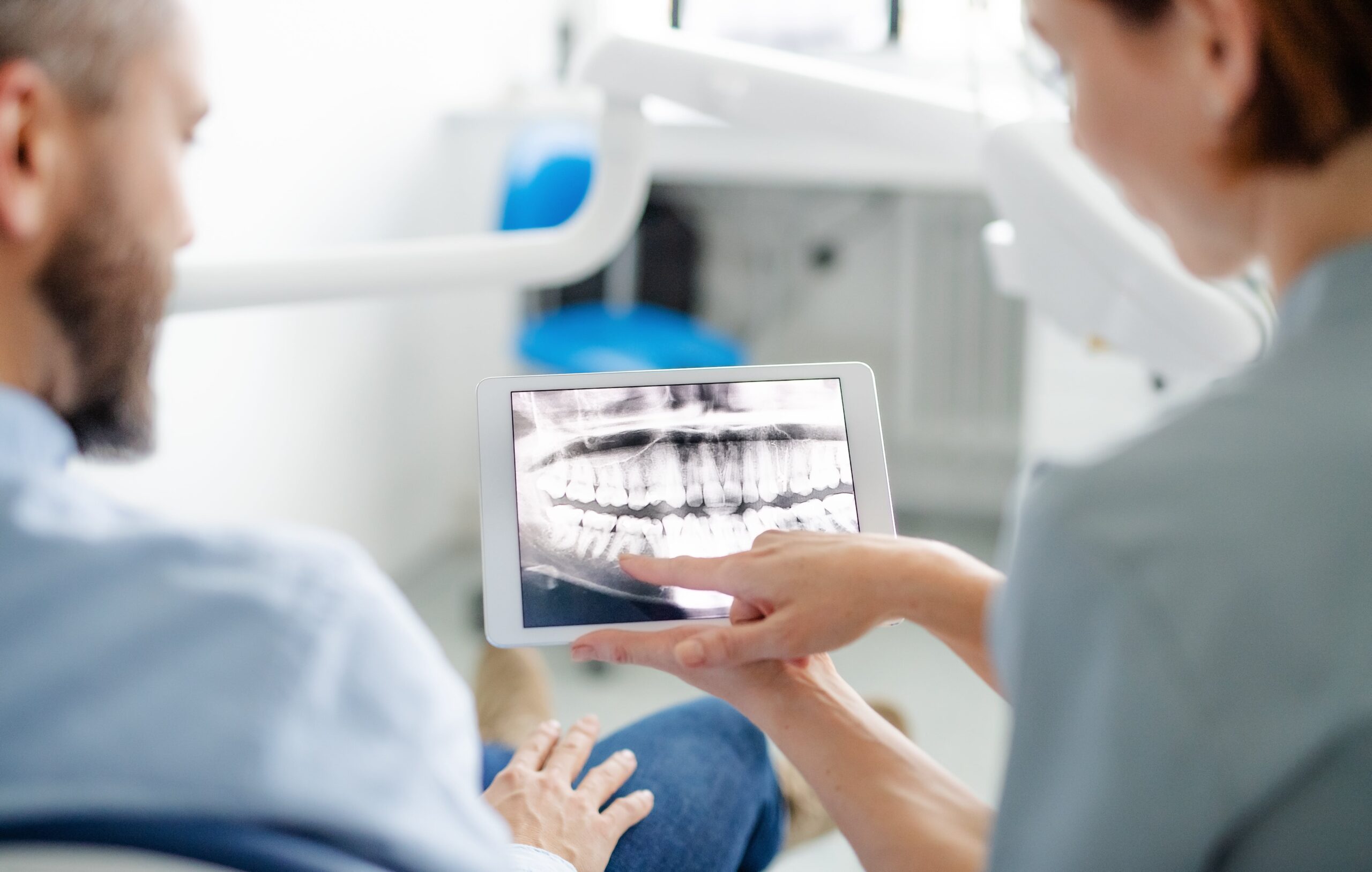 dentist explaining surgery to patient