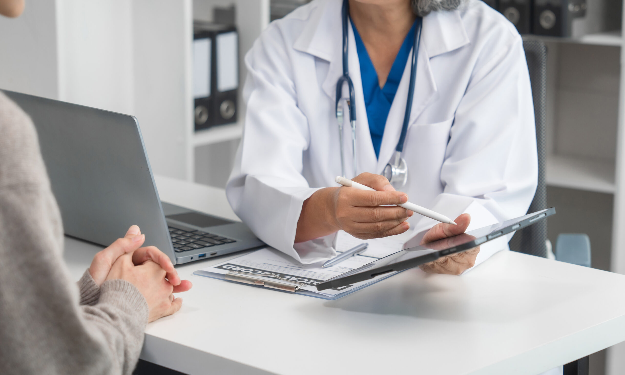 Senior woman reviewing financial documents at home, representing understanding Medi-Cal asset limits and preparing for renewal.
